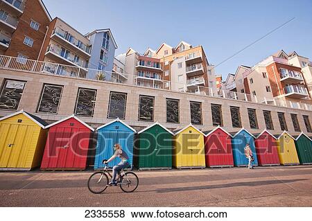 Cyclist, Pedestrian, Colorful Beach Huts And Apartments At Honeycombe Beach Development Next To Boscombe Pier; Bournemouth, Dorset, England, Uk View Large Photo Image Stock Photo - Cyclist, Pedestrian, Colorful Beach Huts And Apartments At Honeycombe Beach Development Next To Boscombe Pier; Bournemouth, Dorset, England, Uk. Fotosearch
