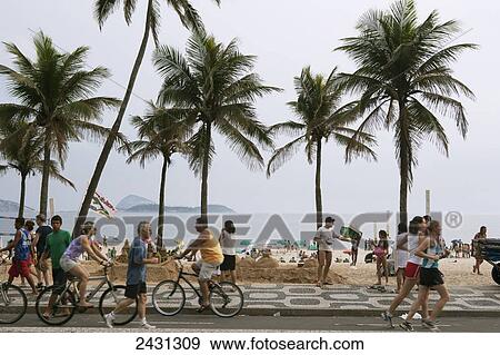 Cyclists and joggers on the promenade at Copacabana beach; Rio de Janeiro, Brazil View Large Photo Image Stock Photo - Cyclists and joggers on the promenade at Copacabana beach; Rio de Janeiro, Brazil. Fotosearch