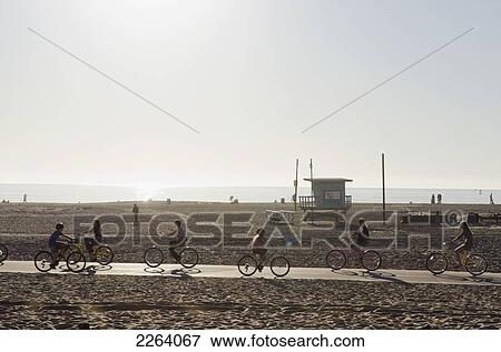Stock Photo - Cyclists On A Paved Path Through The Beaches Of Santa Monica; Los Angeles California Usa. Fotosearch