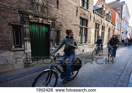 Stock Photo - Cyclists on a street, Bruges (Brugge), West Flanders, Belgium. Fotosearch