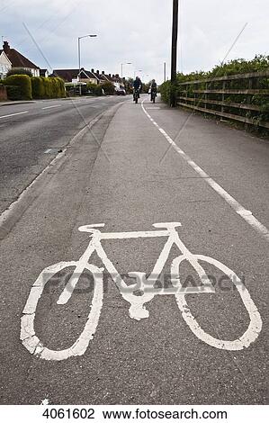 Stock Image - Cyclists on designated bike lane; Thatcham, Berkshire, England. Fotosearch