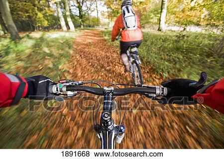 Stock Photo - Cyclists On Track In Autumn. Fotosearch