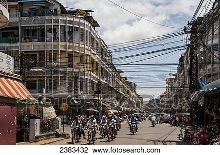 Cyclists riding down the street in a french colonial city; Phnom Penh, Cambodia View Large Photo Image Stock Image - Cyclists riding down the street in a french colonial city; Phnom Penh, Cambodia. Fotosearch