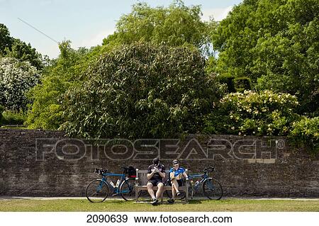 Stock Photo - Cyclists Stopping For A Snack In Lacock, Wiltshire, Uk. Fotosearch
