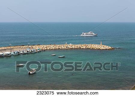 Stock Photography - Cyprus, Agios Georgios, Boats in harbor and sailing yacht. Fotosearch