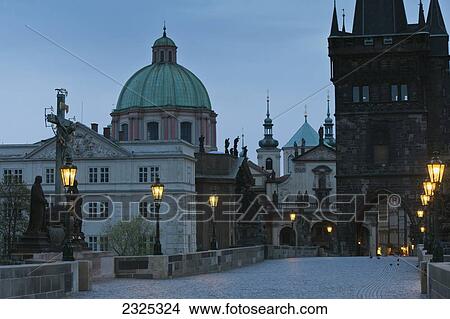 Czech Republic, Cross and statue monument with lamp posts along path illuminated at dusk; Prague View Large Photo Image Picture - Czech Republic, Cross and statue monument with lamp posts along path illuminated at dusk; Prague. Fotosearch