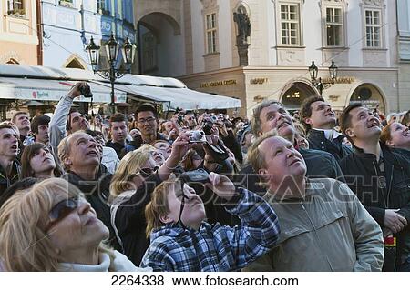 Stock Photo - Czech Republic, Group of tourist photographing and looking up; Prague. Fotosearch