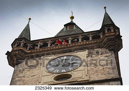 Stock Photo - Czech Republic, Low angle view of tourists in clock tower; Prague. Fotosearch