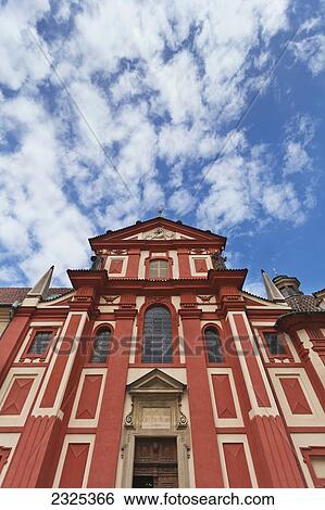 Stock Photograph - Czech Republic, Low angle view of building with red and yellow facade; Prague. Fotosearch