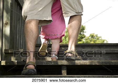 Dad Helping His Baby Daughter Climb Stairs; Ontario Canada View Large Photo Image Stock Image - Dad Helping His Baby Daughter Climb Stairs; Ontario Canada. Fotosearch