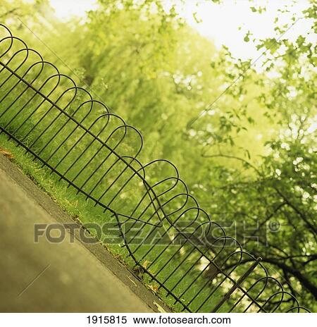 Stock Photography - Damaged Fence In Park. Fotosearch