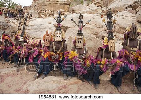 Dancers wearing Kananga mask at the Dama celebration in Tireli, Mali View Large Photo Image Stock Image - Dancers wearing Kananga mask at the Dama celebration in Tireli, Mali. Fotosearch
