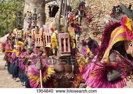 Dancers wearing Kananga mask at the Dama celebration in Tireli, Mali View Large Photo Image Stock Image - Dancers wearing Kananga mask at the Dama celebration in Tireli, Mali. Fotosearch