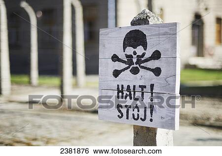 Stock Photograph - Danger sign in Auschwitz concentration camp; Osweciem, Poland. Fotosearch