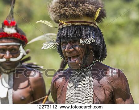 Stock Image - Dani man wearing an elaborate headdress of bird of paradise or cassowary feathers, Obia Village, Baliem Valley, Central Highlands of Western New Guinea, Papua, Indonesia. Fotosearch
