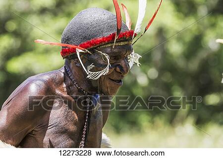 Dani man wearing an elaborate headdress of bird of paradise or cassowary feathers, Obia Village, Baliem Valley, Central Highlands of Western New Guinea, Papua, Indonesia View Large Photo Image Stock Photo - Dani man wearing an elaborate headdress of bird of paradise or cassowary feathers, Obia Village, Baliem Valley, Central Highlands of Western New Guinea, Papua, Indonesia. Fotosearch