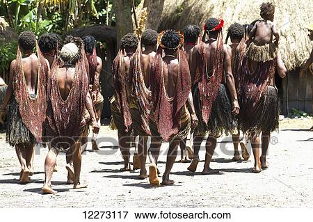 Stock Photo - Dani women wearing noken, a multifunctional knotted or woven bag, which is hung from the head, Obia Village, Baliem Valley, Central Highlands of Western New Guinea, Papua, Indonesia. Fotosearch
