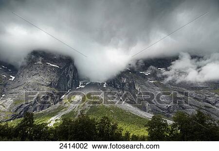 Dark clouds cover the mountain peaks; Andalsnes, Rauma, Norway View Large Photo Image Stock Image - Dark clouds cover the mountain peaks; Andalsnes, Rauma, Norway. Fotosearch