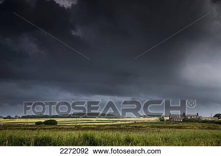 Dark Storm Clouds Over A Landscape; Northumberland England View Large Photo Image Stock Image - Dark Storm Clouds Over A Landscape; Northumberland England. Fotosearch
