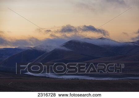 Stock Photo - Dawn Colors The Sky Over The Richardson Mountains Along The Dempster Highway; Yukon Canada. Fotosearch
