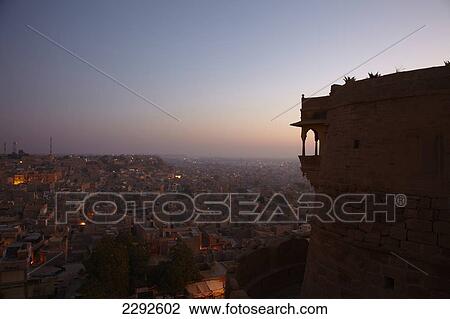 Stock Image - Dawn over Jaisalmer viewed from terace of Killa Bhawan hotel Jaisalmer Rajasthan India. Fotosearch
