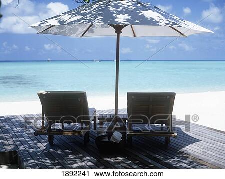 Stock Image - Deck With Chairs And Sunshade With View Of Ocean. Fotosearch