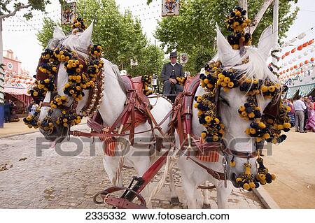 Stock Image - Decorated Horses Of Horse Drawn Wagon During April Feria Festival; Seville, Andalucia, Spain. Fotosearch