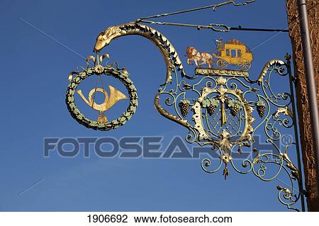 Decorative Gold Sign On A Building Against A Blue Sky; Breisach Am Rhein, Germany View Large Photo Image Stock Image - Decorative Gold Sign On A Building Against A Blue Sky; Breisach Am Rhein, Germany. Fotosearch