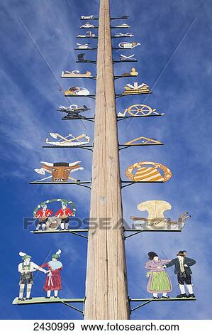 Stock Photo - Decorative images mounted up a wooden post; Murnau, Bavaria, Germany. Fotosearch