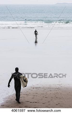 Dedicated surfers in full cover wetsuit heading out to the chilly winter waters at Whitesands Beach on the Pembrokeshire Coast Path; Pembrokeshire, Wales View Large Photo Image Stock Photo - Dedicated surfers in full cover wetsuit heading out to the chilly winter waters at Whitesands Beach on the Pembrokeshire Coast Path; Pembrokeshire, Wales. Fotosearch