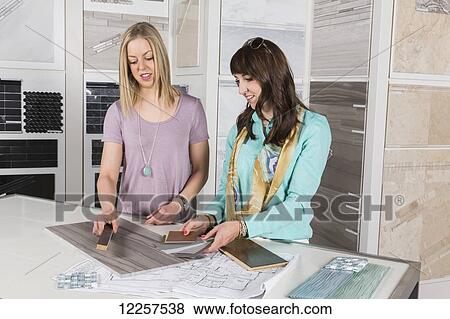 Design consultant and interior designer selecting tiles in showroom of tile store; Edmonton, Alberta, Canada View Large Photo Image Stock Photo - Design consultant and interior designer selecting tiles in showroom of tile store; Edmonton, Alberta, Canada. Fotosearch