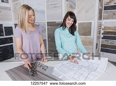 Design consultant and interior designer selecting tiles in showroom of tile store; Edmonton, Alberta, Canada View Large Photo Image Stock Photo - Design consultant and interior designer selecting tiles in showroom of tile store; Edmonton, Alberta, Canada. Fotosearch