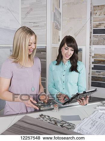 Design consultant and interior designer selecting tiles in showroom of tile store; Edmonton, Alberta, Canada View Large Photo Image Stock Photo - Design consultant and interior designer selecting tiles in showroom of tile store; Edmonton, Alberta, Canada. Fotosearch