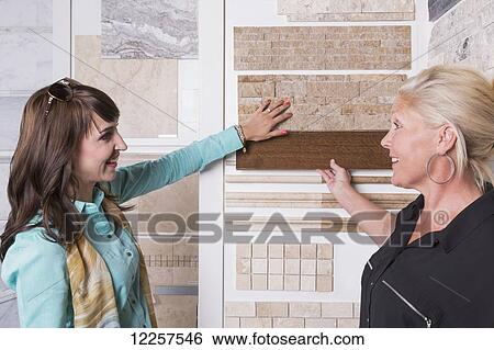 Design consultant and interior designer selecting tiles in showroom of tile store; Edmonton, Alberta, Canada View Large Photo Image Stock Photograph - Design consultant and interior designer selecting tiles in showroom of tile store; Edmonton, Alberta, Canada. Fotosearch