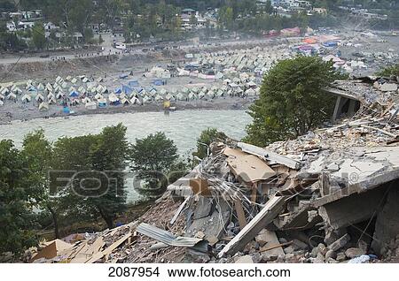 Destroyed Building And Tents In A Relief Camp After The 8 October 2005 Earthquake, Muzaffarabad, Azad Kashmir, Pakistan View Large Photo Image Picture - Destroyed Building And Tents In A Relief Camp After The 8 October 2005 Earthquake, Muzaffarabad, Azad Kashmir, Pakistan. Fotosearch