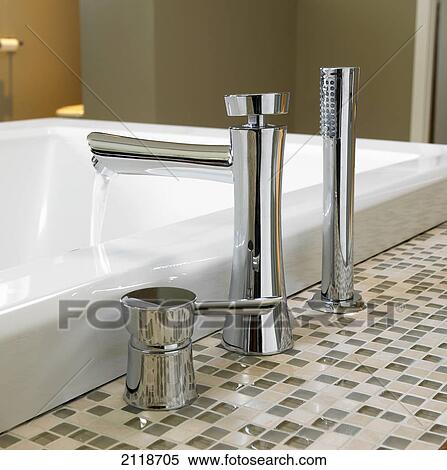 Detail Of Bathroom Faucets With Neutral Square Glass Counter Tiles; Victoria Vancouver Island British Columbia Canada View Large Photo Image Stock Photography - Detail Of Bathroom Faucets With Neutral Square Glass Counter Tiles; Victoria Vancouver Island British Columbia Canada. Fotosearch