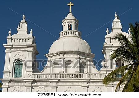 Stock Image - Detail of church surrounded by palm trees; Goa, India. Fotosearch