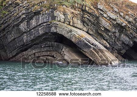 Stock Photo - Detail of curved bedding planes of rock at water's edge; County Clare, Ireland. Fotosearch