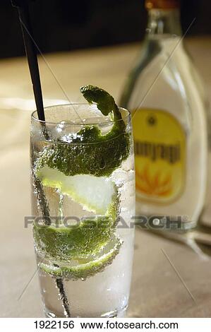 Stock Photograph - Detail Of Gin And Tonic With Bottle. Fotosearch