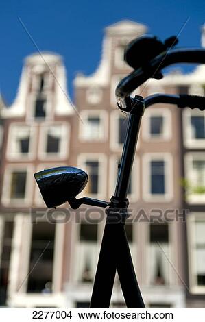 Detail of handelbars of Dutch bicycle in front of gabled houses; Amsterdam, Holland View Large Photo Image Picture - Detail of handelbars of Dutch bicycle in front of gabled houses; Amsterdam, Holland. Fotosearch