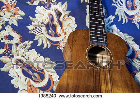 Stock Image - Detail Of Handmade Koa Ukulele On Aloha Print Background. Fotosearch