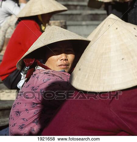 Stock Photo - Detail Of Hats & Woman's Face, Dalat. Fotosearch