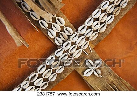 Stock Photo - Detail of leather cape decorated with ornate cowrie shells; Tigray region, Ethiopia. Fotosearch