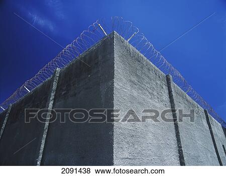 Stock Photo - Detail Of The Main Wall With Razor Wire Of The Prison On Robben Island, Cape Town, South Africa.. Fotosearch
