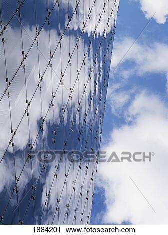 Stock Image - Detail Of The Urbis Building With Clouds And Blue Sky Reflections, Close Up. Fotosearch
