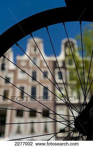 Detail of wheel of Dutch bicycle in front of gabled houses; Amsterdam, Holland View Large Photo Image Stock Image - Detail of wheel of Dutch bicycle in front of gabled houses; Amsterdam, Holland. Fotosearch