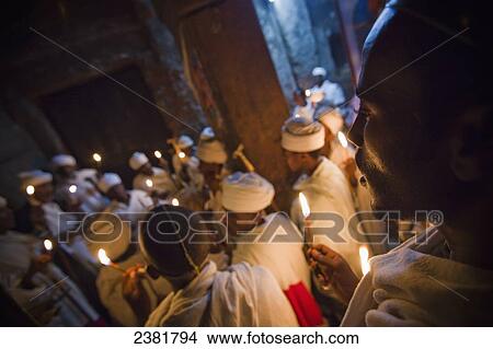 Details of nighttime worship celebrations taking place in the rock-hewn churches during Orthodox Easter; Lalibela, Ethiopia View Large Photo Image Picture - Details of nighttime worship celebrations taking place in the rock-hewn churches during Orthodox Easter; Lalibela, Ethiopia. Fotosearch