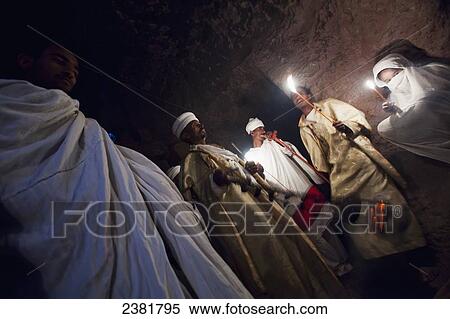 Details of nighttime worship celebrations taking place in the rock-hewn churches during Orthodox Easter; Lalibela, Ethiopia View Large Photo Image Stock Photography - Details of nighttime worship celebrations taking place in the rock-hewn churches during Orthodox Easter; Lalibela, Ethiopia. Fotosearch