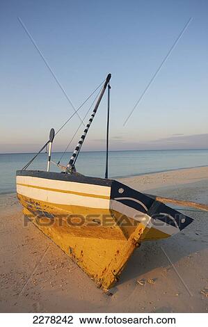 Stock Image - Dhow on the beach along the Indian Ocean; Mozambique. Fotosearch