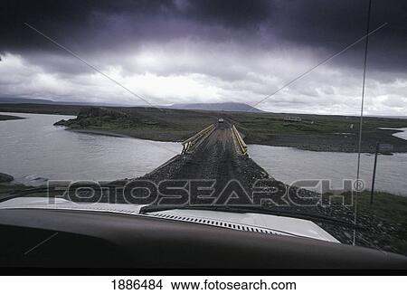 Picture - Dirt Road Going Through Water As Seen Through Car Windscreen. Fotosearch